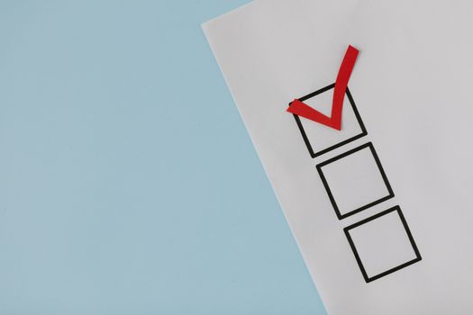 A simple white paper checklist with one red checkmark, ideal for concepts like completion or approval.